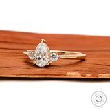 Side profile of pear and round diamond three stone ring