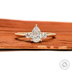 Pear and round three stone lab diamond ring in 10k yellow gold front view