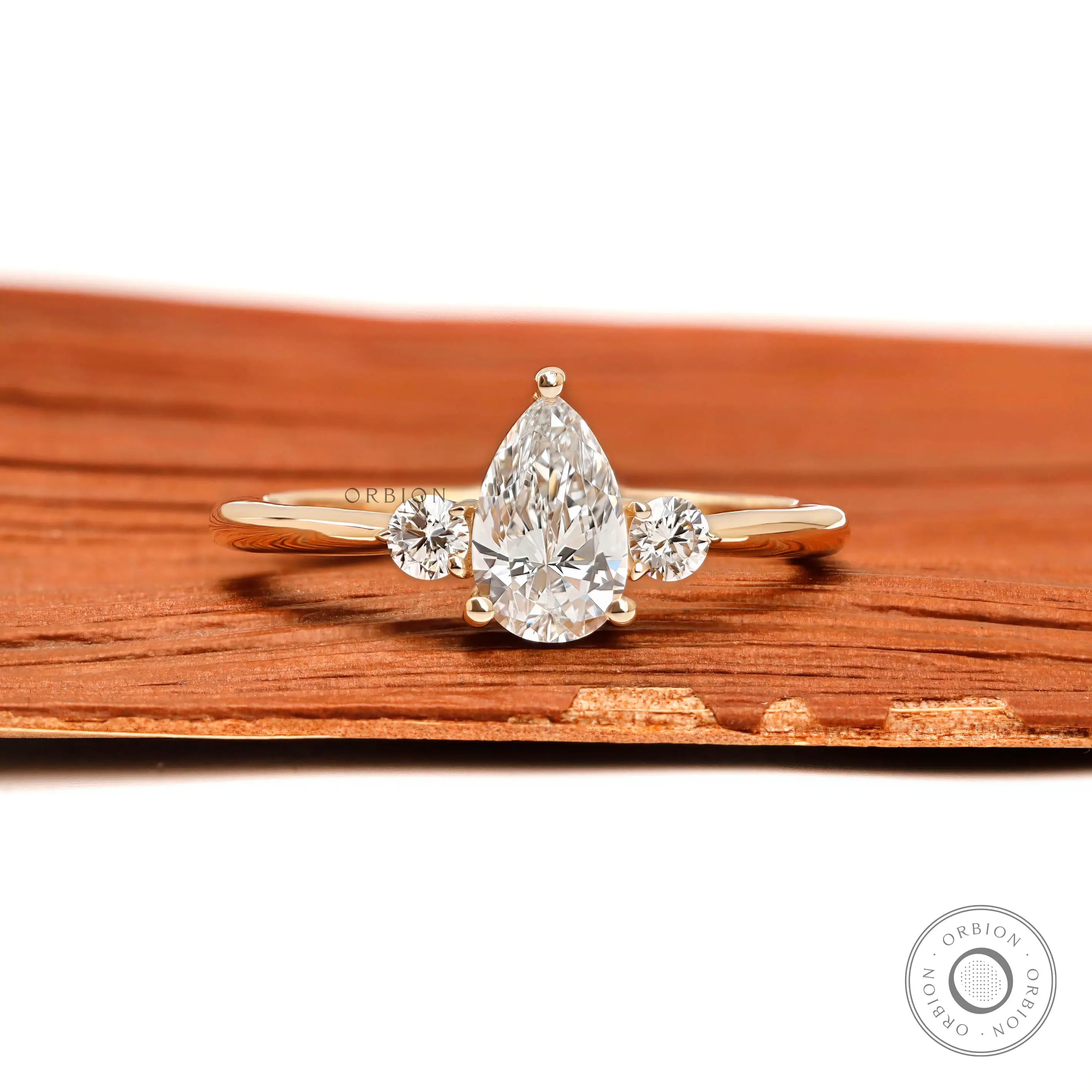 Pear and round three stone lab diamond ring in 10k yellow gold front view
