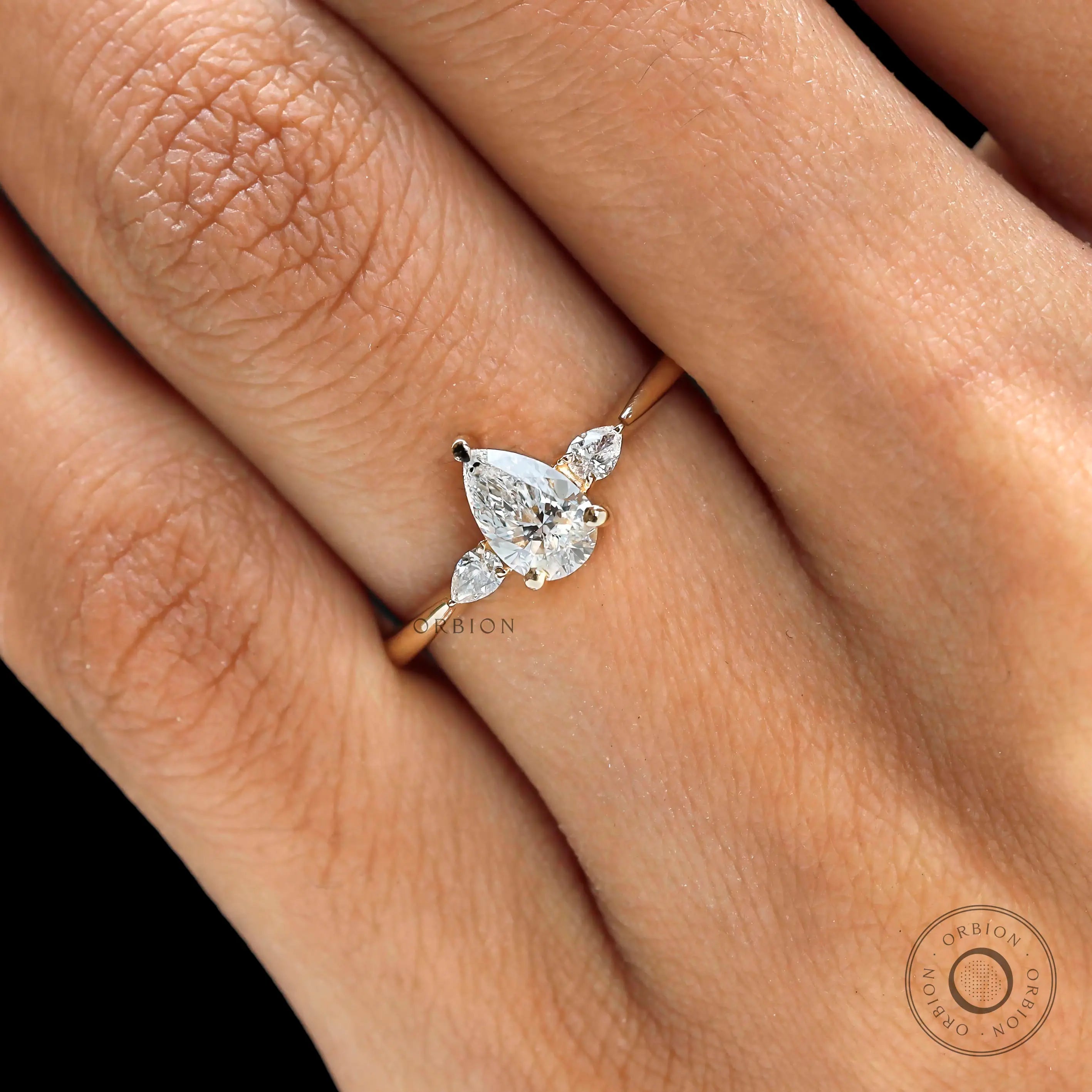 Close up of pear shaped center stone with pear side stones
