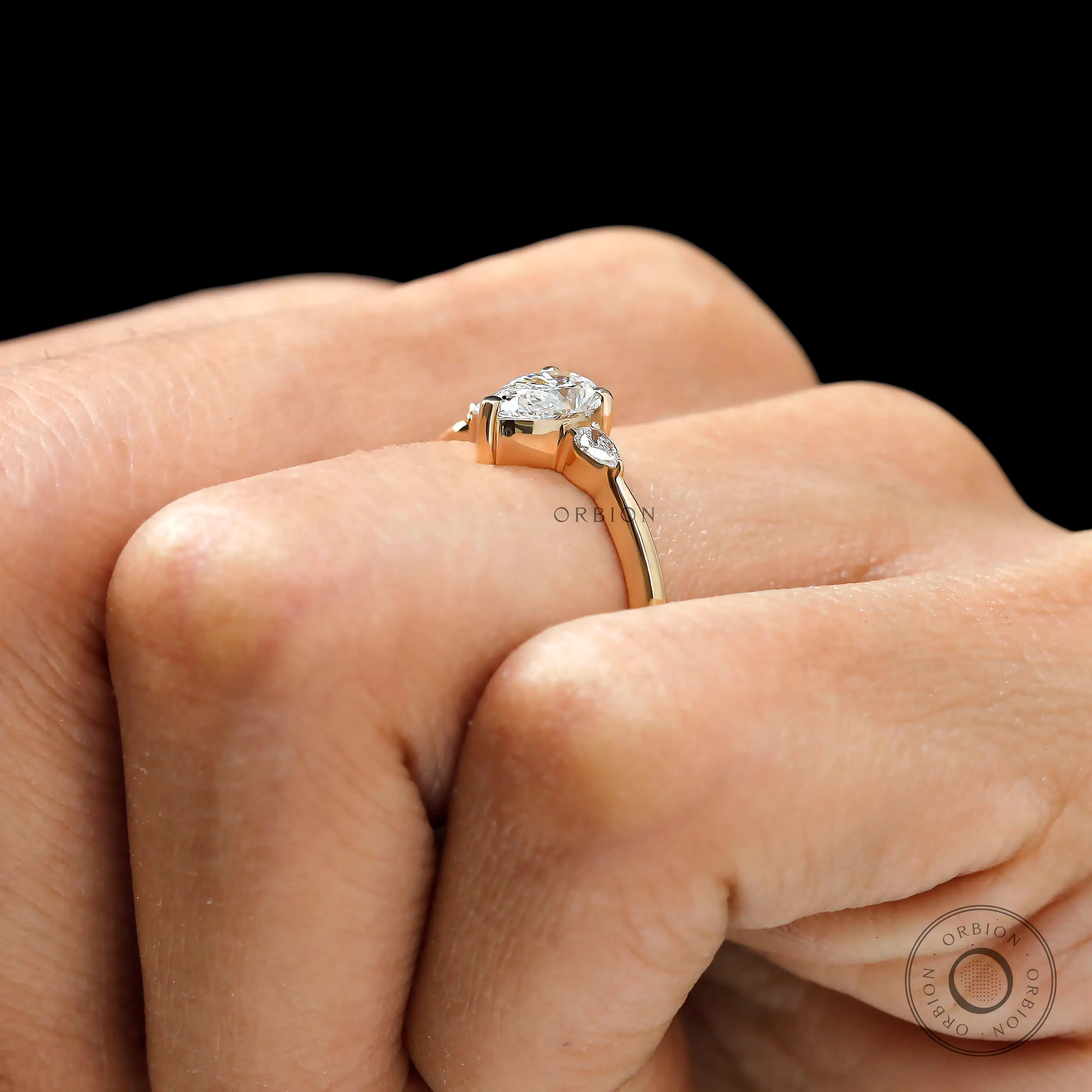 Elegant pear cut three stone ring for proposal in yellow gold
