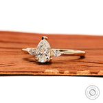 Side view of pear cut lab diamond engagement ring in yellow gold