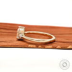 Minimal three stone pear engagement ring with slim gold band