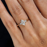 Close up of marquise cut lab diamond ring with round accents