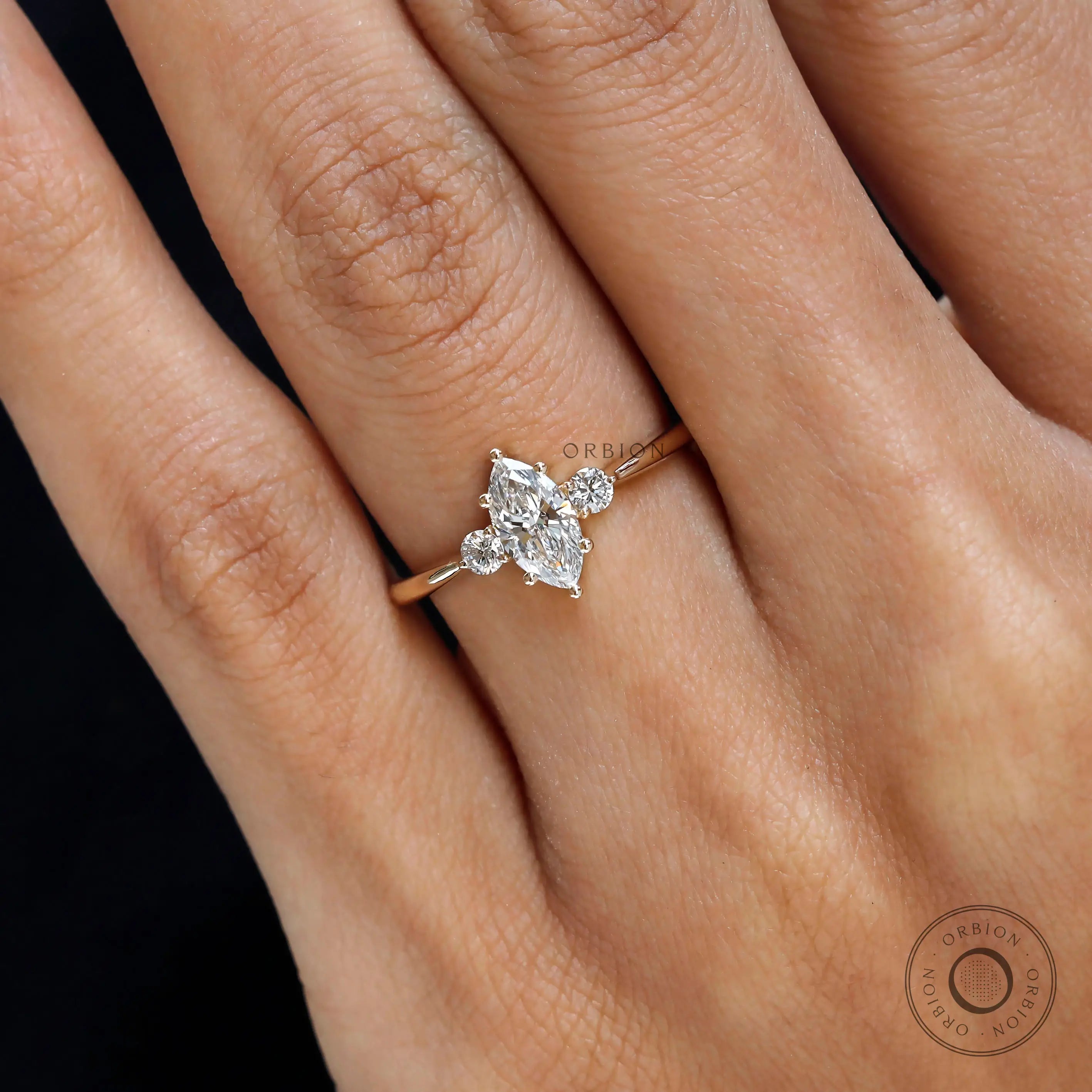 Close up of marquise cut lab diamond ring with round accents