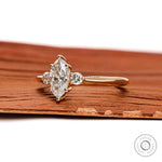 Side profile of marquise three stone lab diamond ring slim yellow gold band