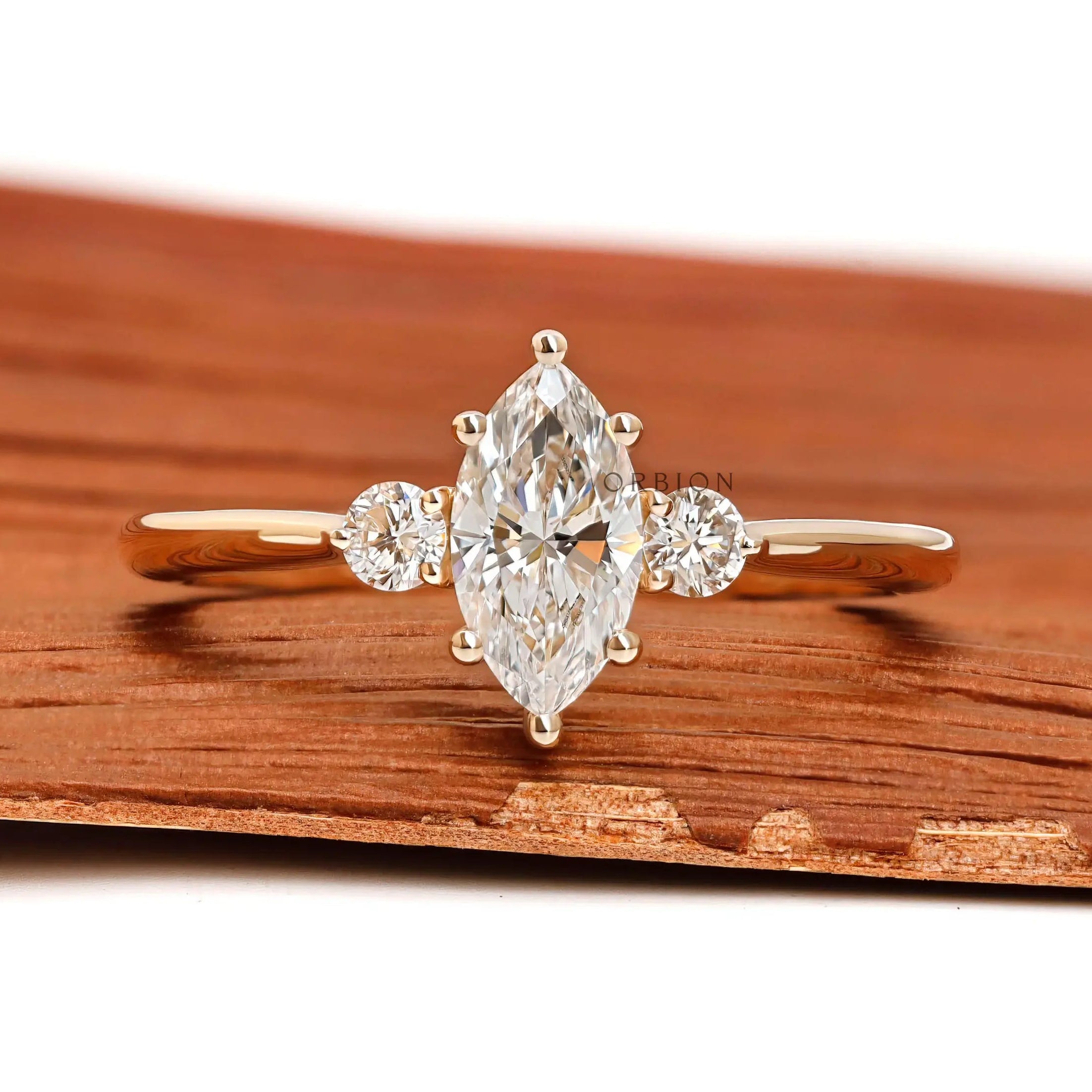 Marquise and round cut three stone lab diamond ring in 10k yellow gold front view