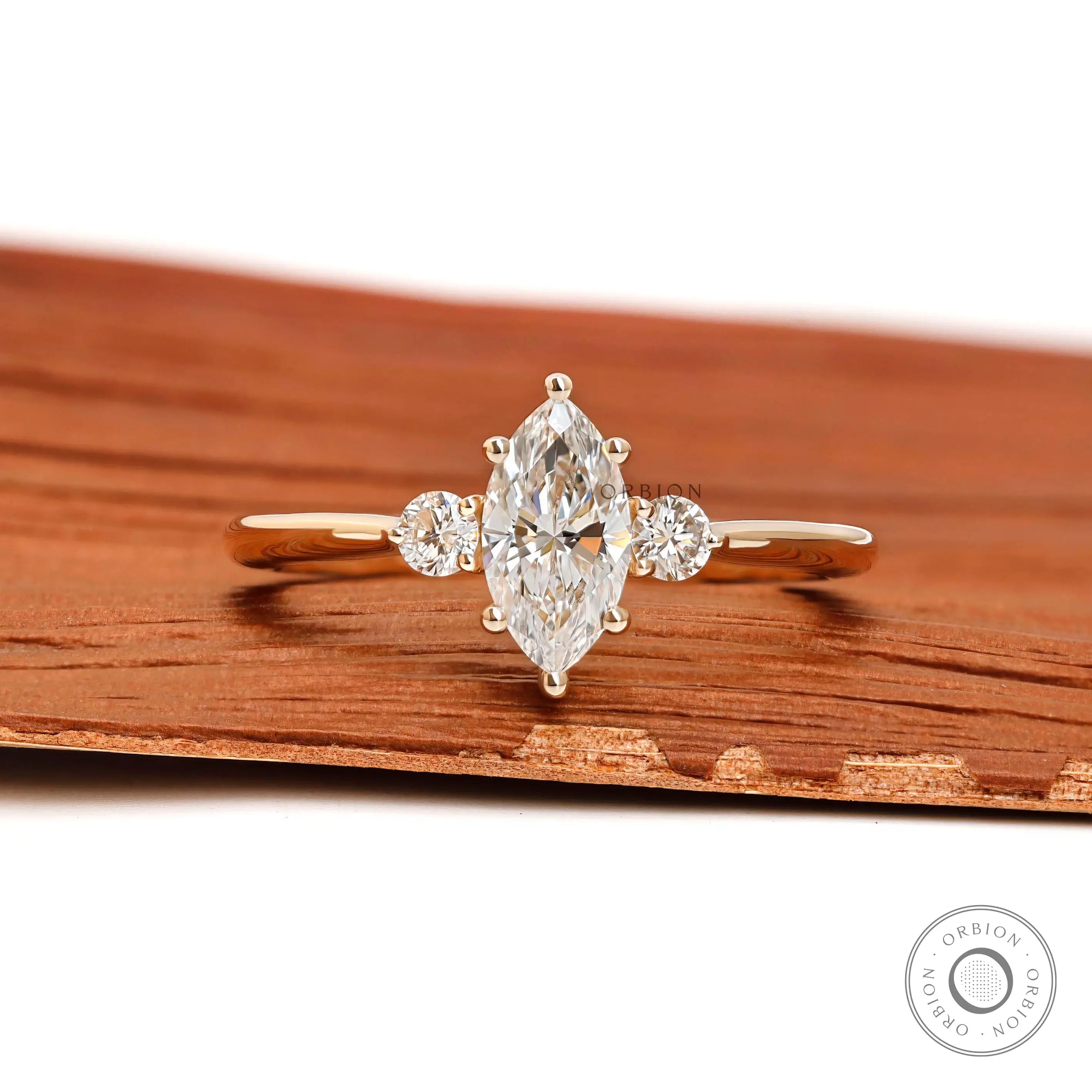 Marquise and round cut three stone lab diamond ring in 10k yellow gold front view