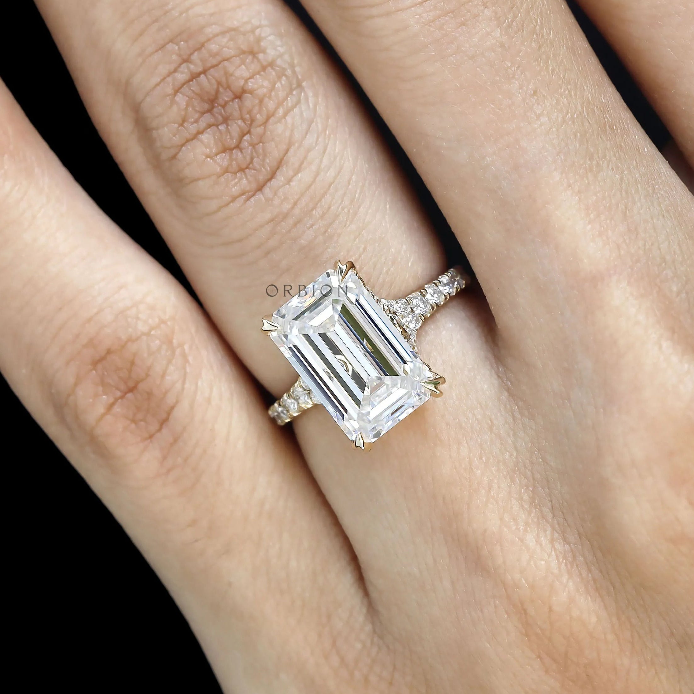 Big emerald cut moissanite or lab diamond engagement ring with split shank and pave accents