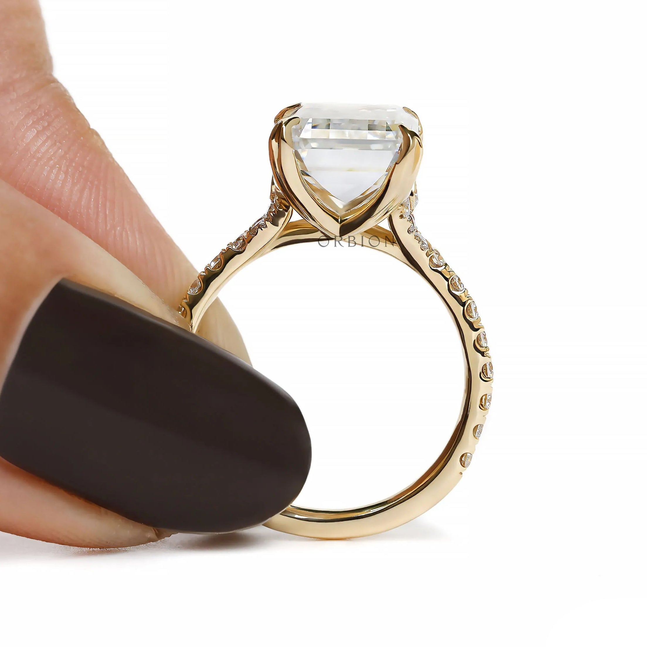 solitaire emerald cut moissanite ring with pave cathedral in 10k yellow gold