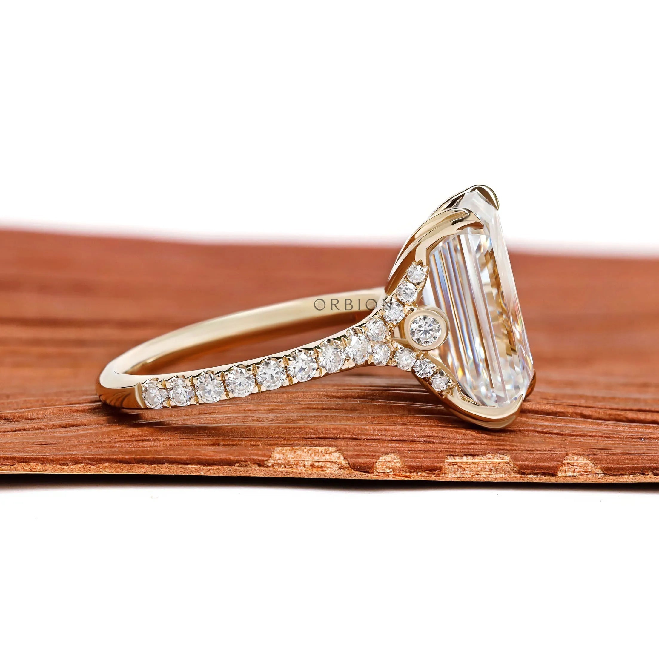 Elegant 4.5 ct emerald cut moissanite engagement ring with pave split shank in yellow gold