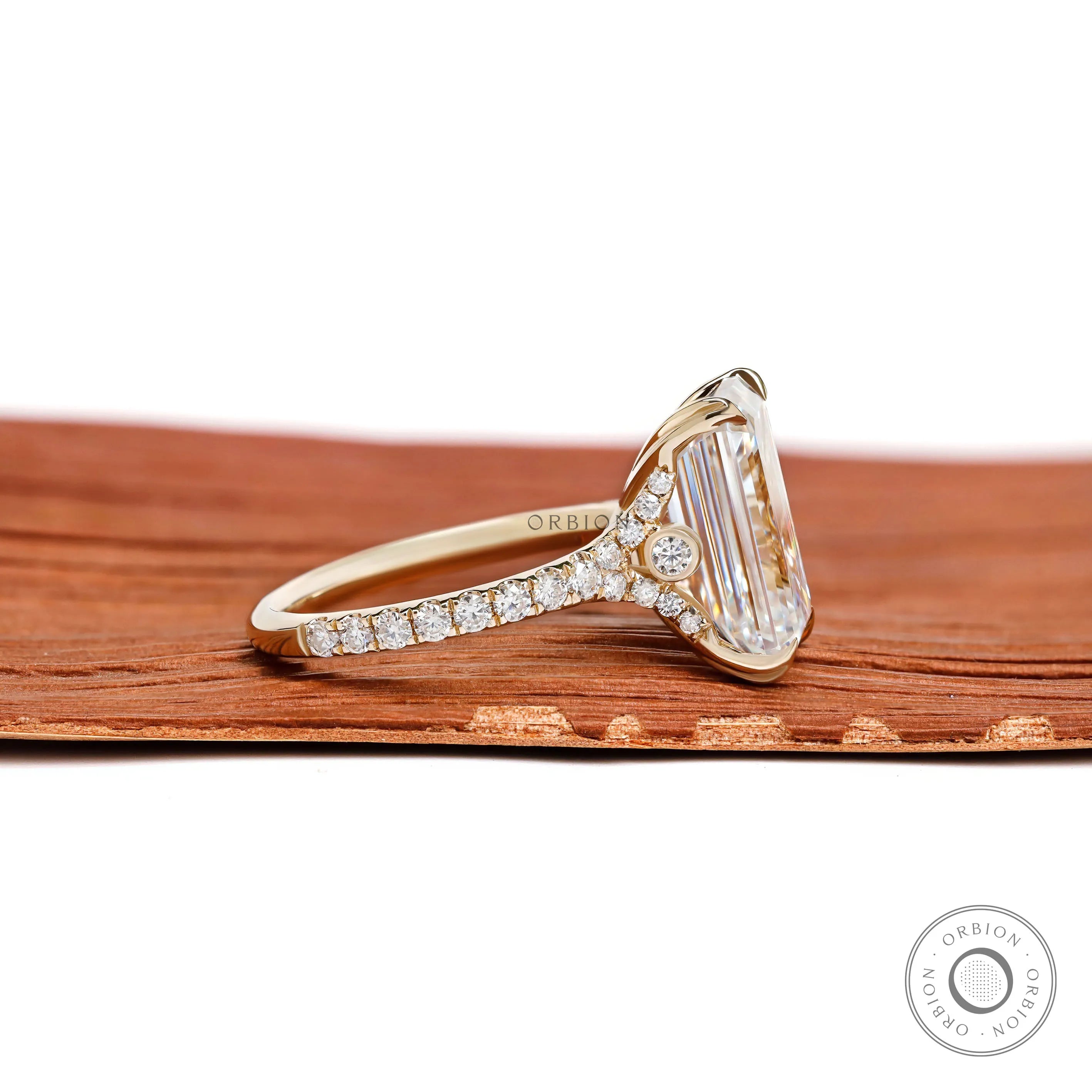 Elegant 4.5 ct emerald cut moissanite engagement ring with pave split shank in yellow gold