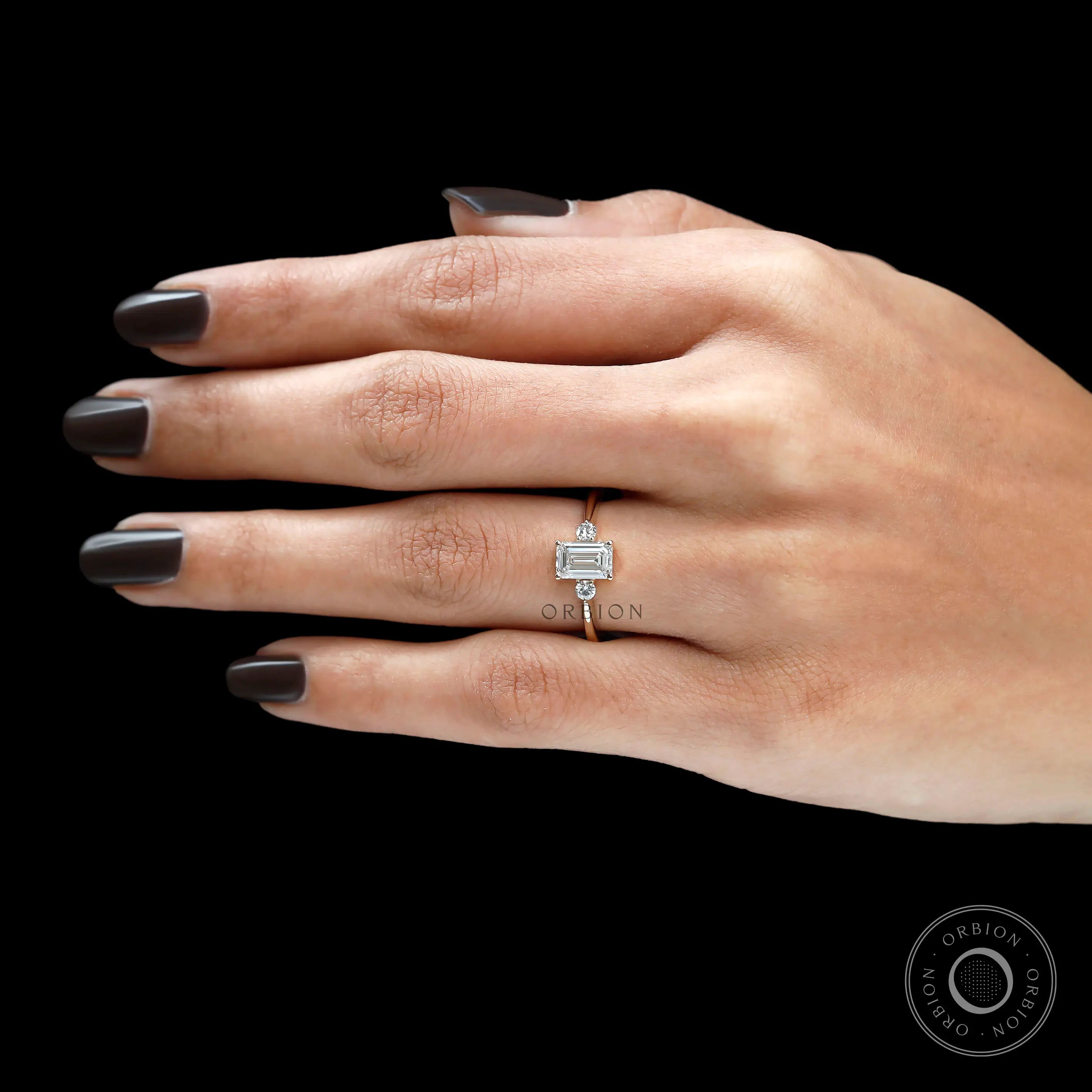 Refined emerald cut women’s trilogy ring lab diamond option on finger