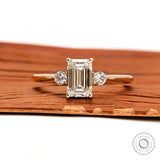 Emerald cut three stone lab diamond ring in 10k yellow gold front view
