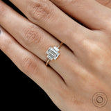 Close up emerald cut center stone and baguette side stones