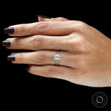 Emerald cut moissanite engagement ring in 10k yellow gold on finger