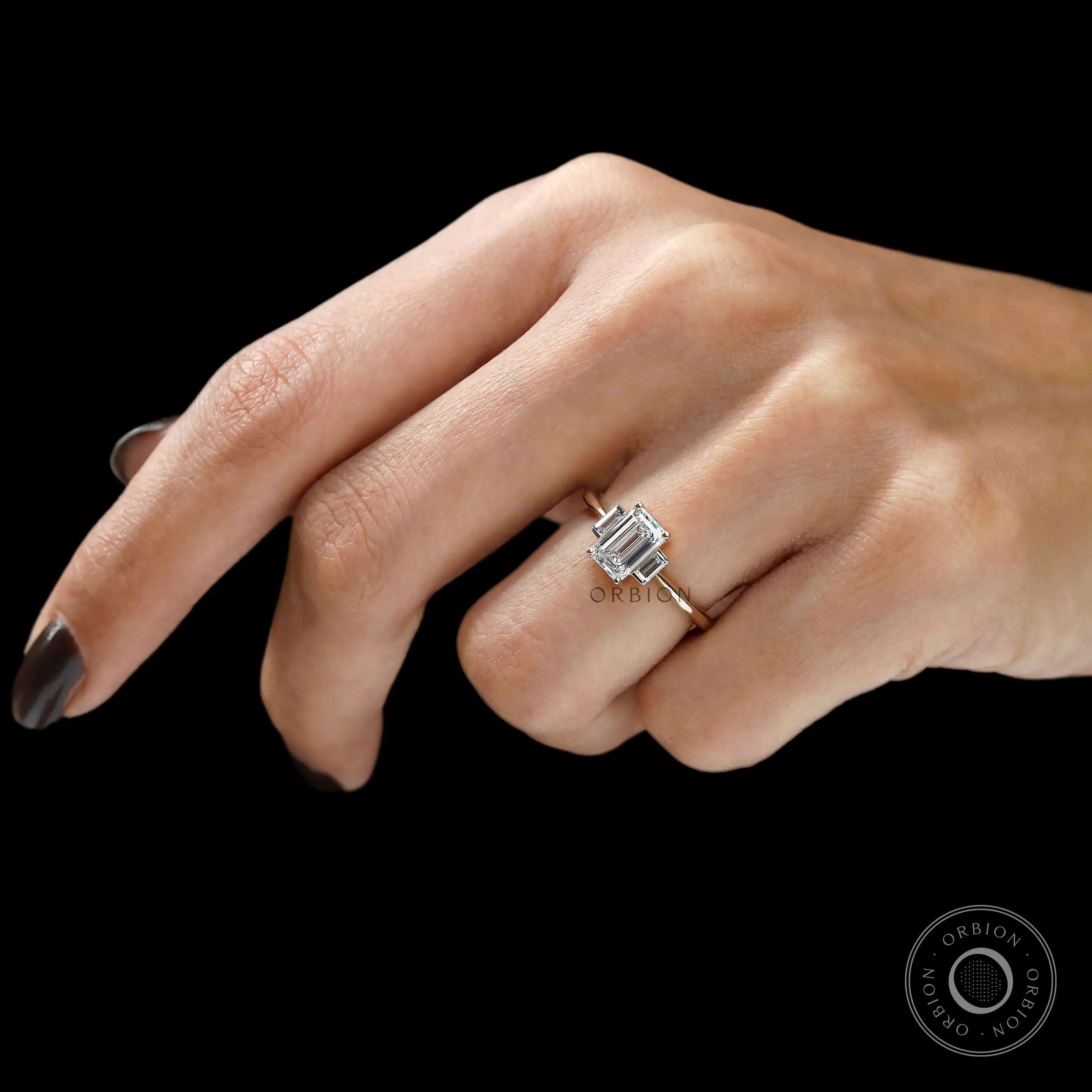 Three stone emerald cut engagement ring with step cut stones