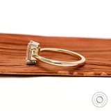 Minimal three stone emerald cut engagement ring yellow gold
