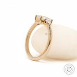 Minimal yellow gold three stone engagement ring profile view