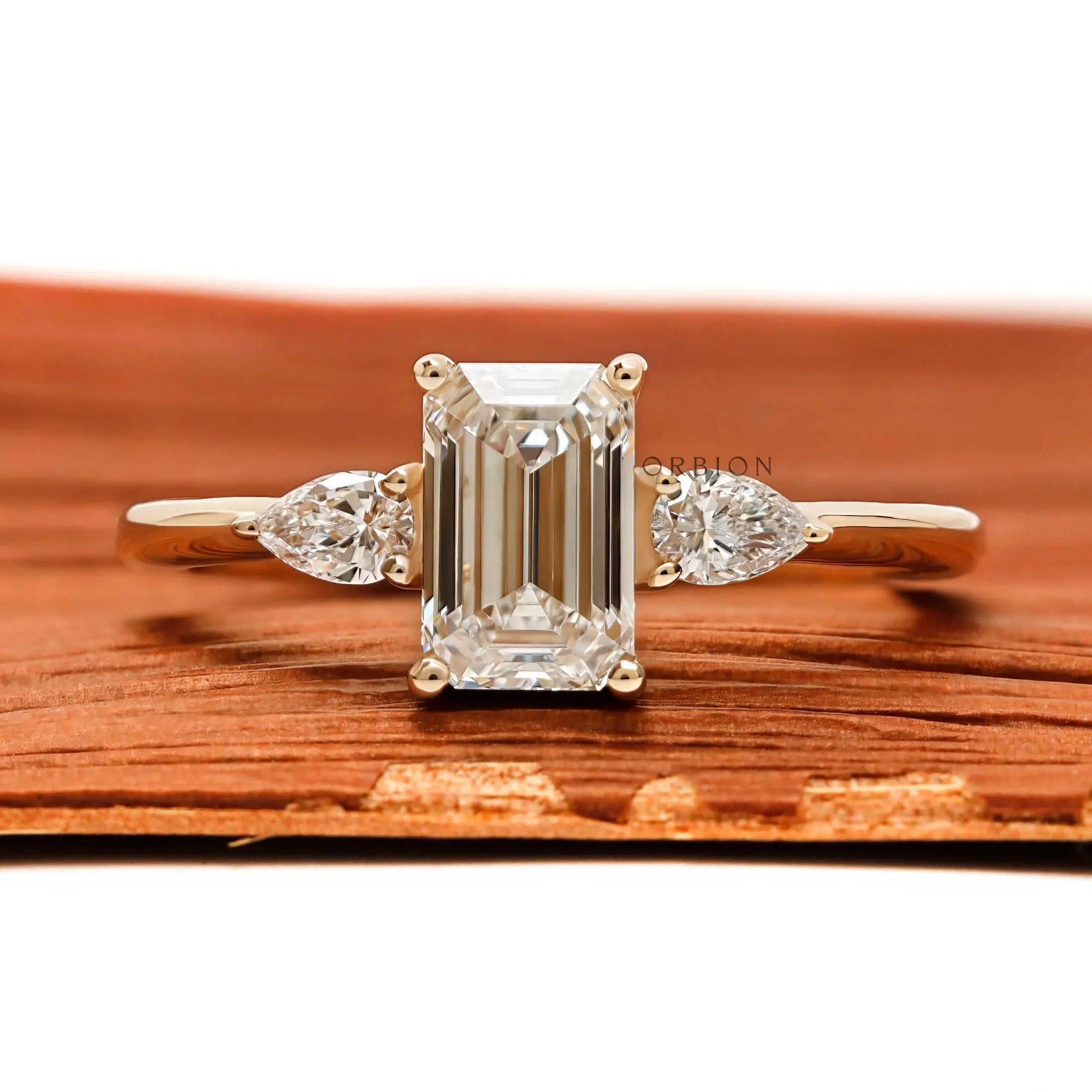 Three stone emerald cut and pear lab diamond engagement ring in 10k yellow gold