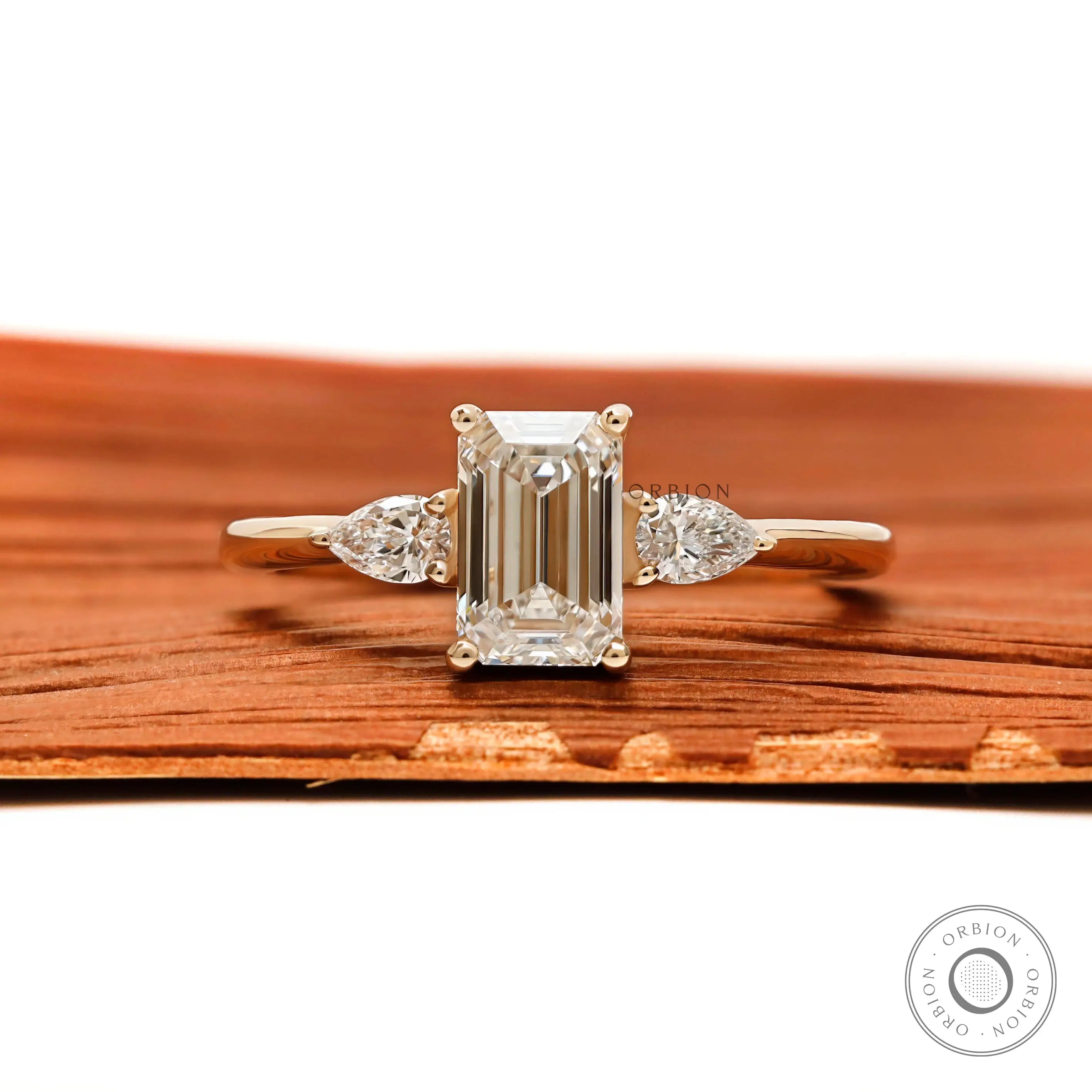 Three stone emerald cut and pear lab diamond engagement ring in 10k yellow gold
