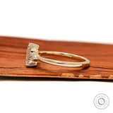 Prong set emerald cut engagement ring with pear accents
