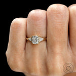 Three stone engagement ring showing bezel center and prong side stones close up