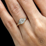 Close up view of bezel set cushion stone with prong set trillion diamonds