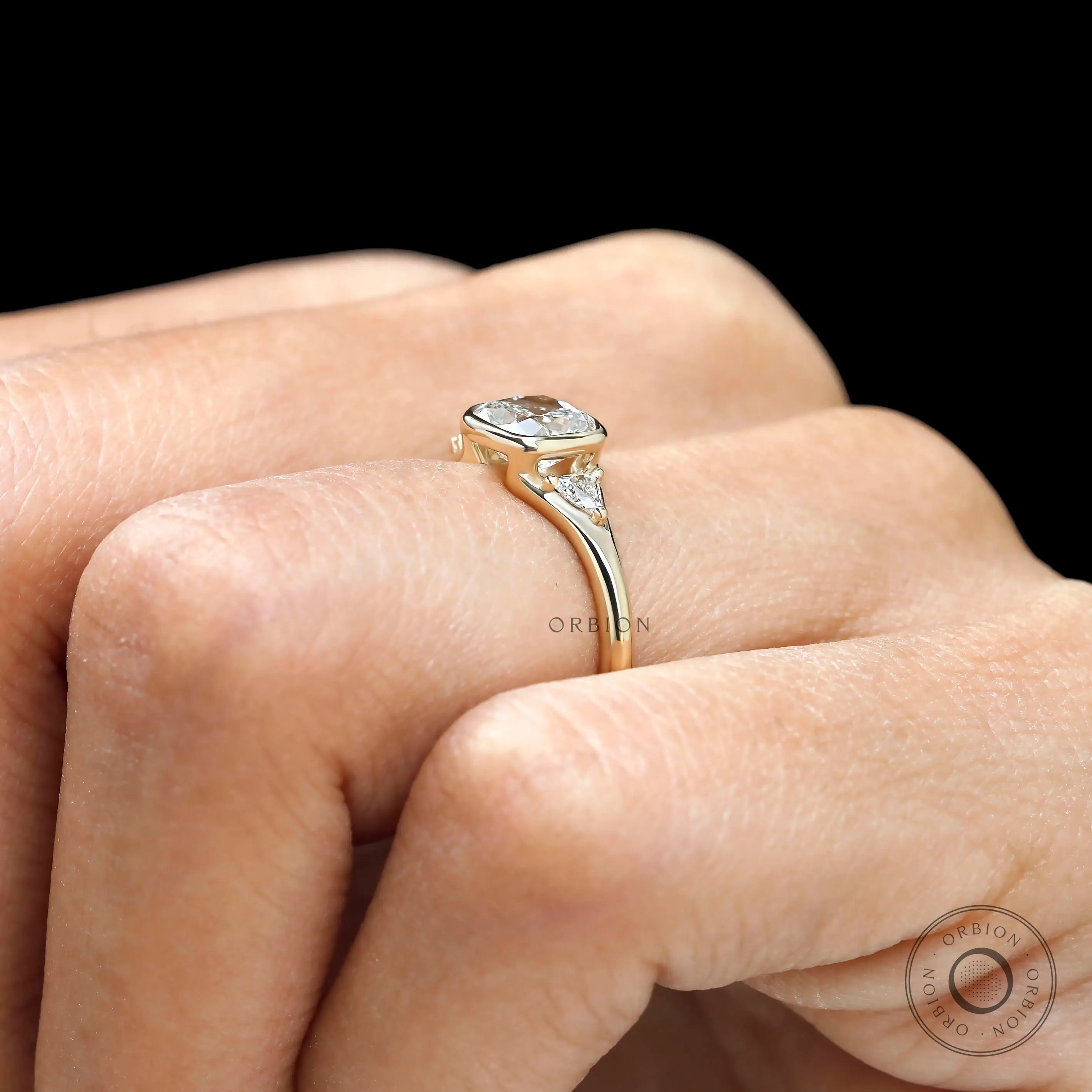 Floating three stone engagement ring with mixed settings on finger