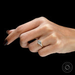 Cushion bezel engagement ring worn on hand in yellow gold