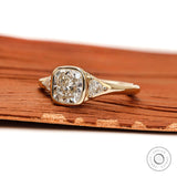 Three stone engagement ring showing bezel center and prong side stones