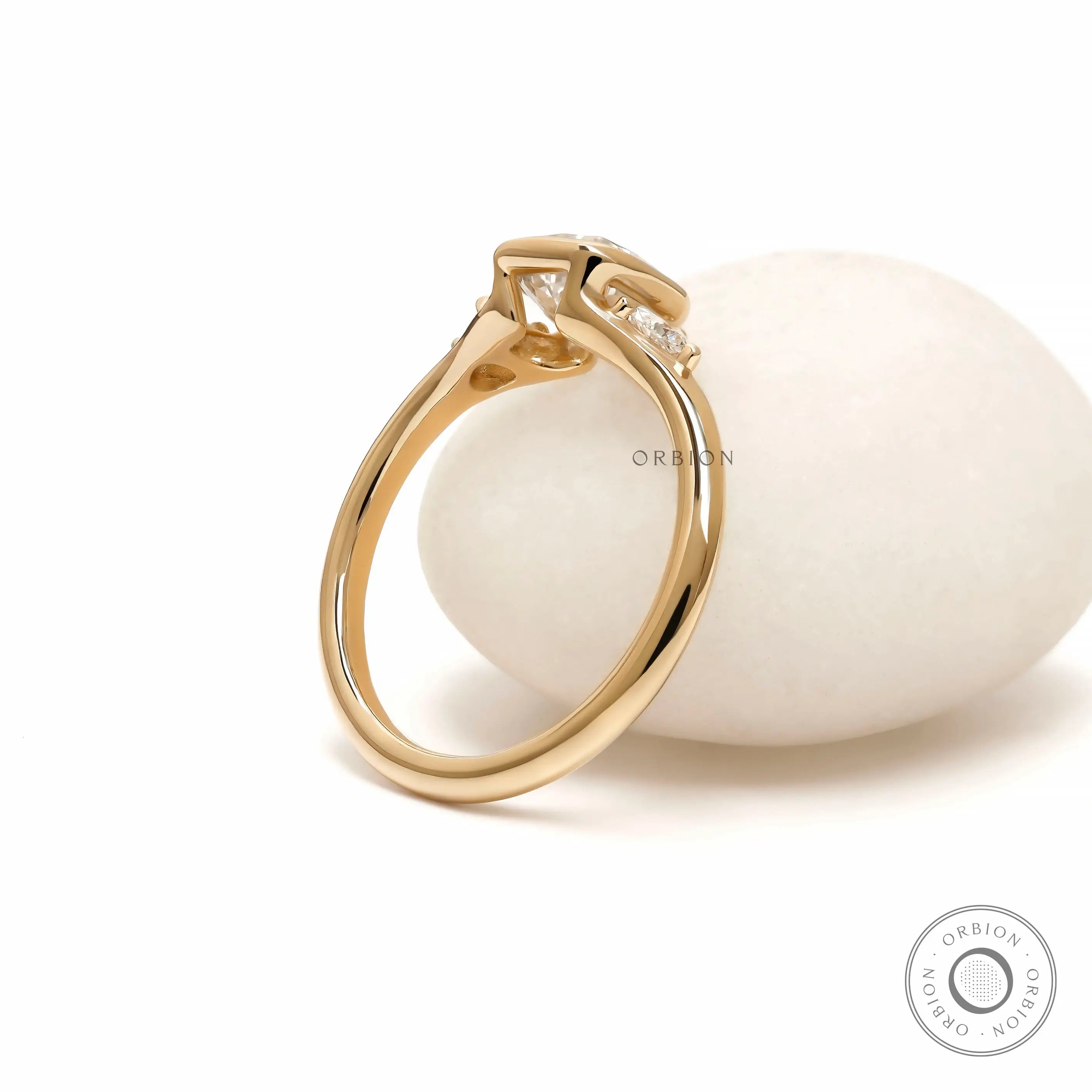 Minimalist yellow gold engagement ring with cushion bezel center stone