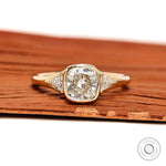 Floating three stone cushion bezel engagement ring with trillion side stones in yellow gold