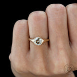 Minimalist bezel set champagne moissanite ring on finger
