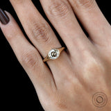Close up of bezel setting champagne moissanite signet ring