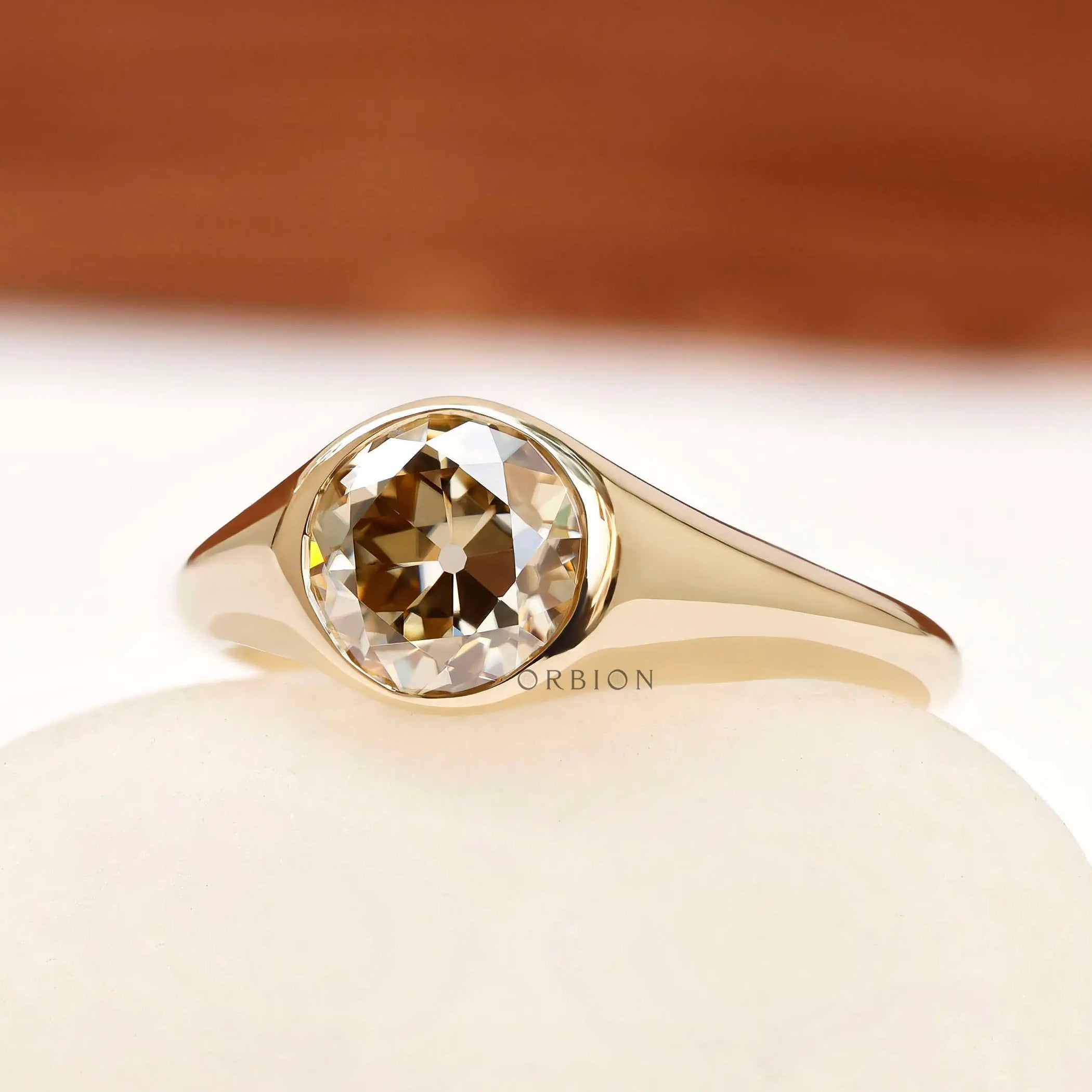 Bezel set champagne moissanite engagement ring side profile