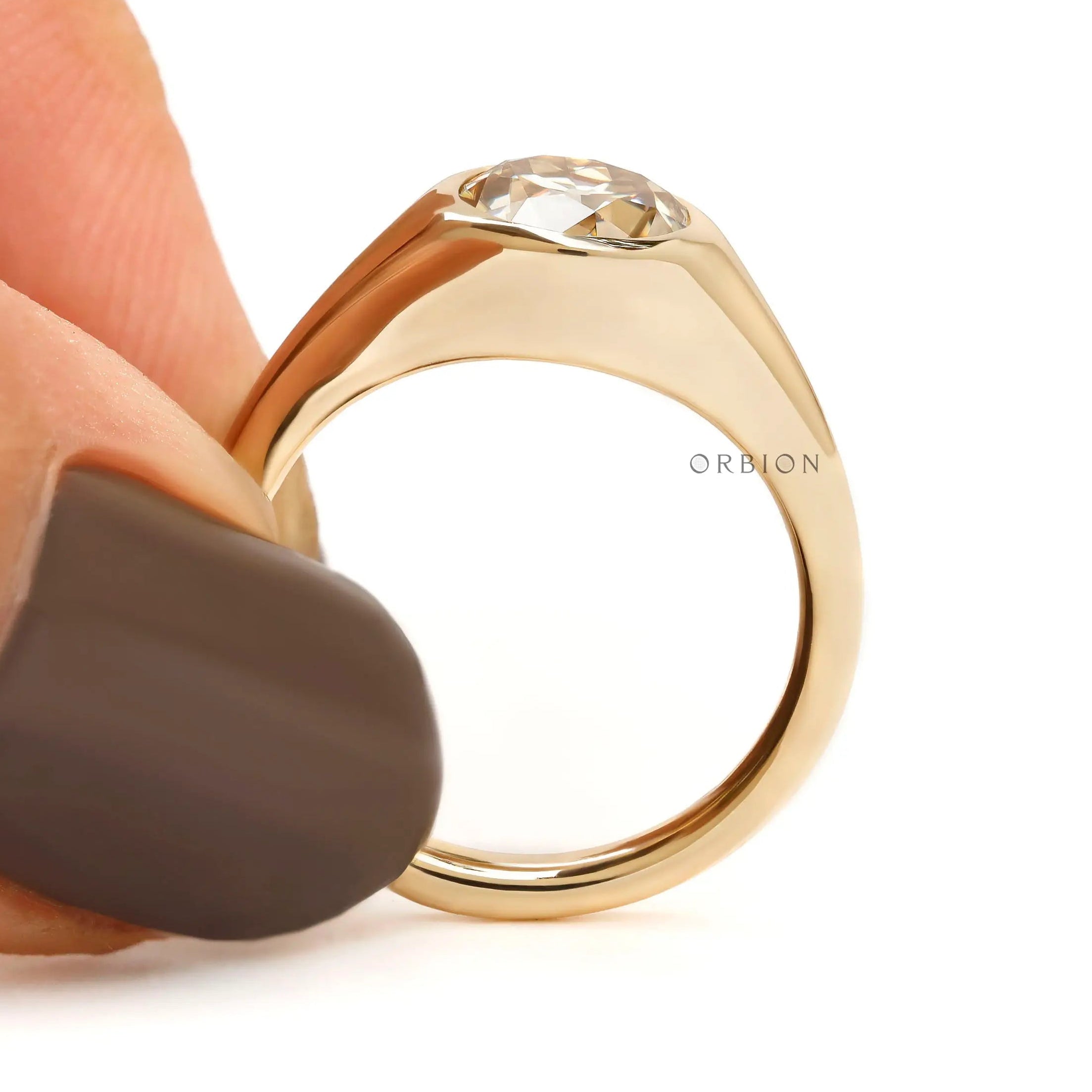 Minimalist bezel set champagne moissanite ring side view