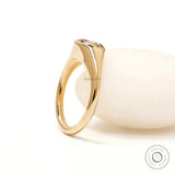 Women’s yellow gold signet ring with round champagne moissanite