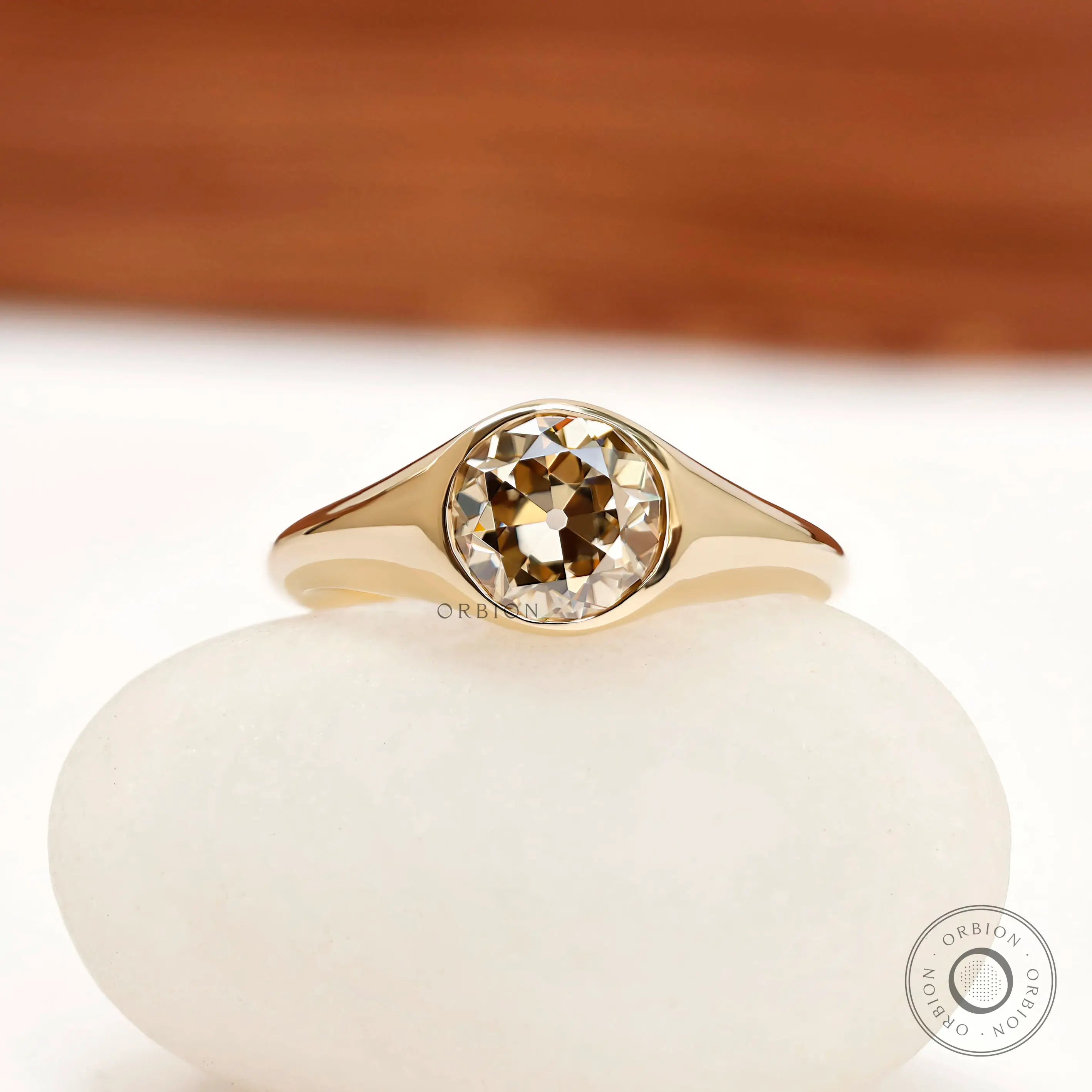 Round old european cut champagne moissanite bezel set signet ring in 14k yellow gold front view