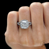 Close up of cushion center stone with round diamond halo