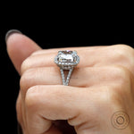 Hand shot of cushion cut halo engagement ring in Platinum 950