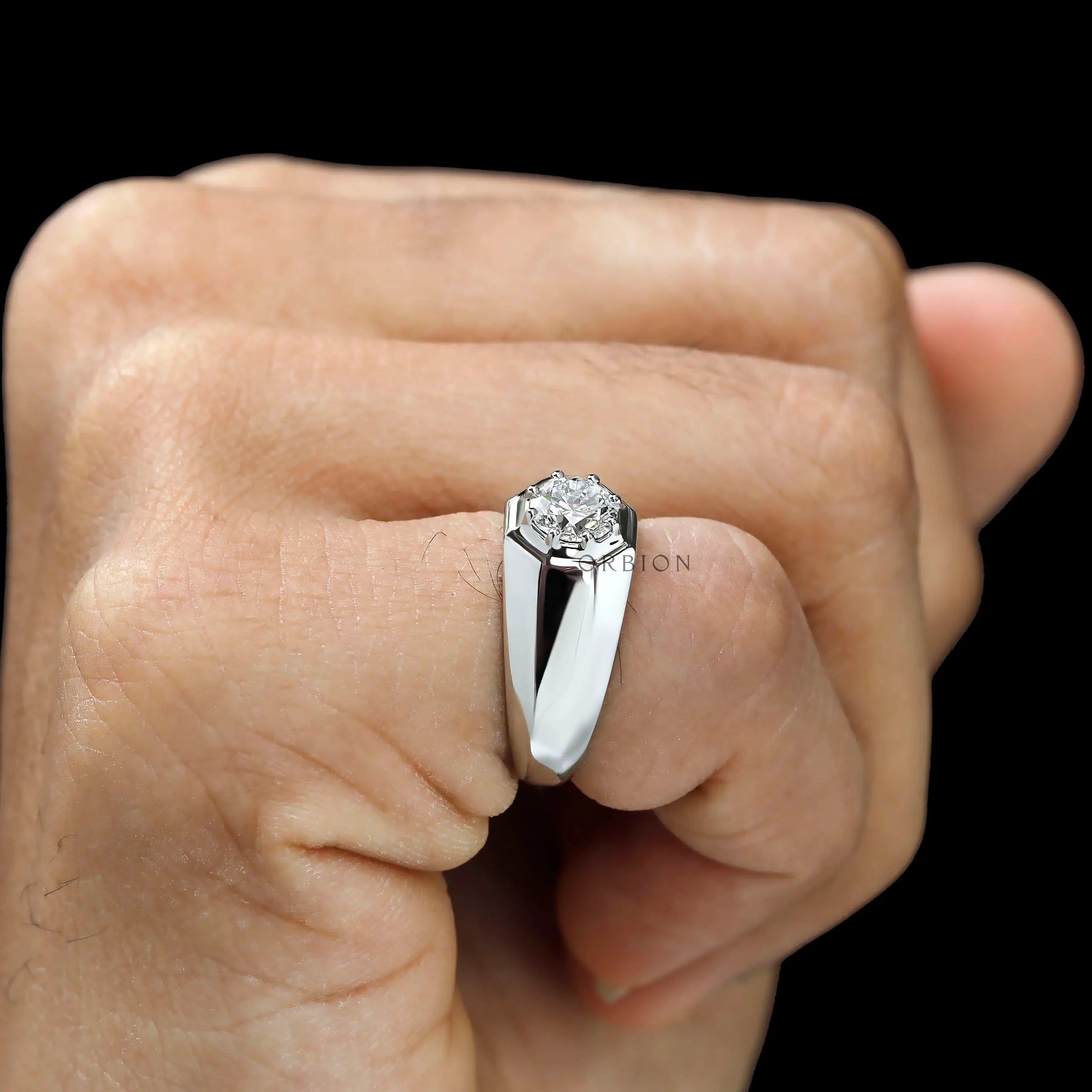 Men’s platinum multi prong diamond ring on finger