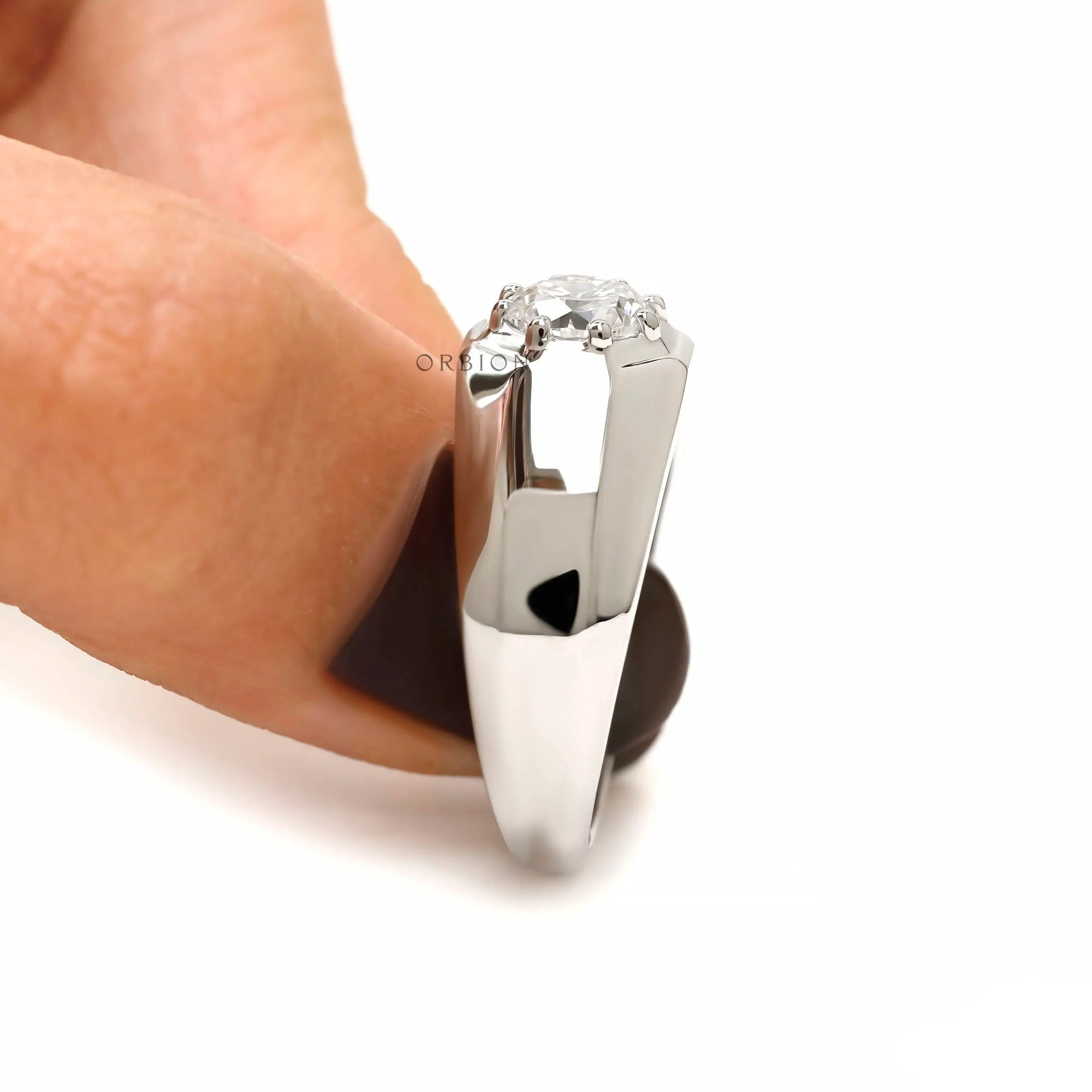Side view of men’s platinum multi prong diamond ring showing tapered shank