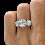 Three stone halo round cut engagement ring in 18K two tone gold