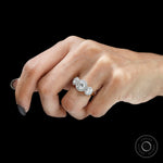 Bridal engagement ring featuring round cut stones and halo design