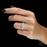Pavé halo detailing on three stone engagement ring