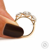 Side profile of cathedral style three stone lab diamond halo engagement ring