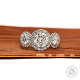 Front view of round three stone moissanite halo engagement ring with cathedral setting