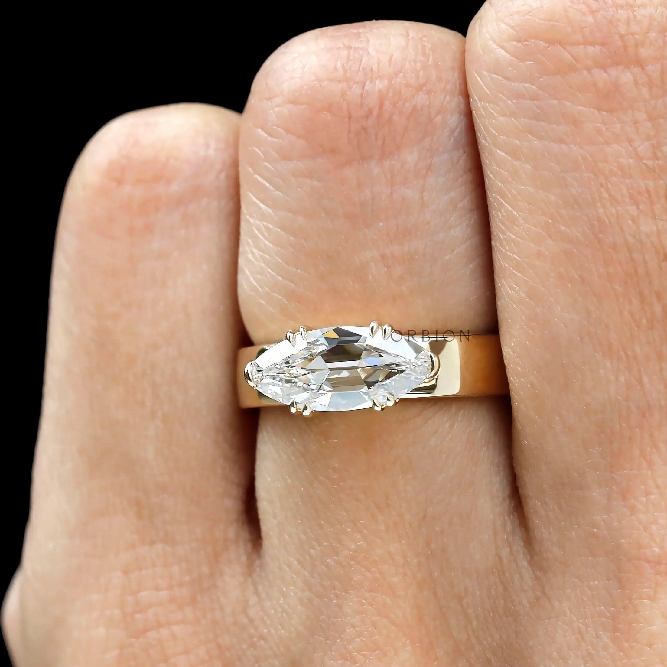 Antique moval cut east west signet engagement ring in yellow gold close up