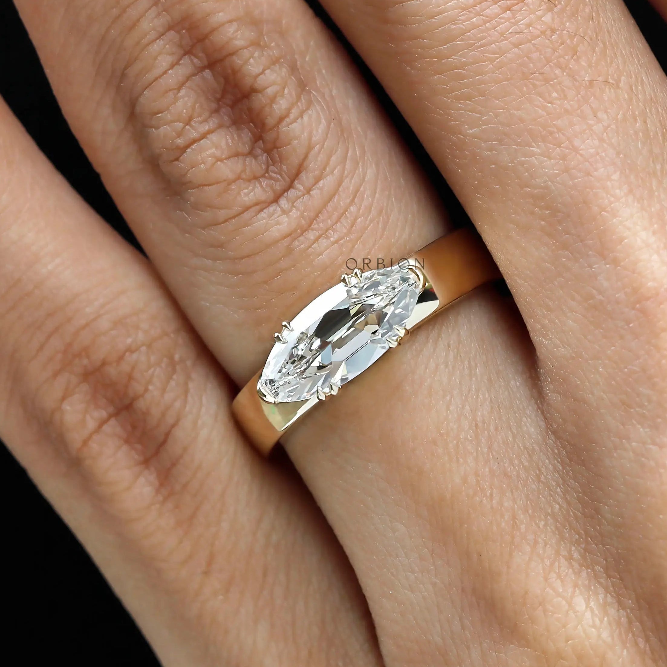 East west set old mine cut moval engagement ring on hand